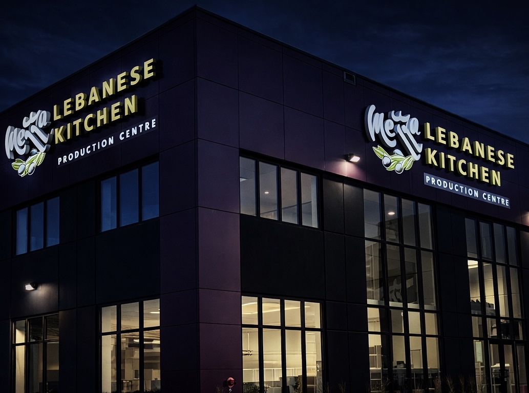 Mezza Lebanese Kitchen — dual-face illuminated building signs on modern commercial facility